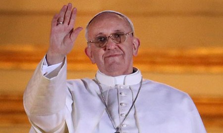 The newly elected Pope Francis I waves to the crowds from St Peter's basilica.